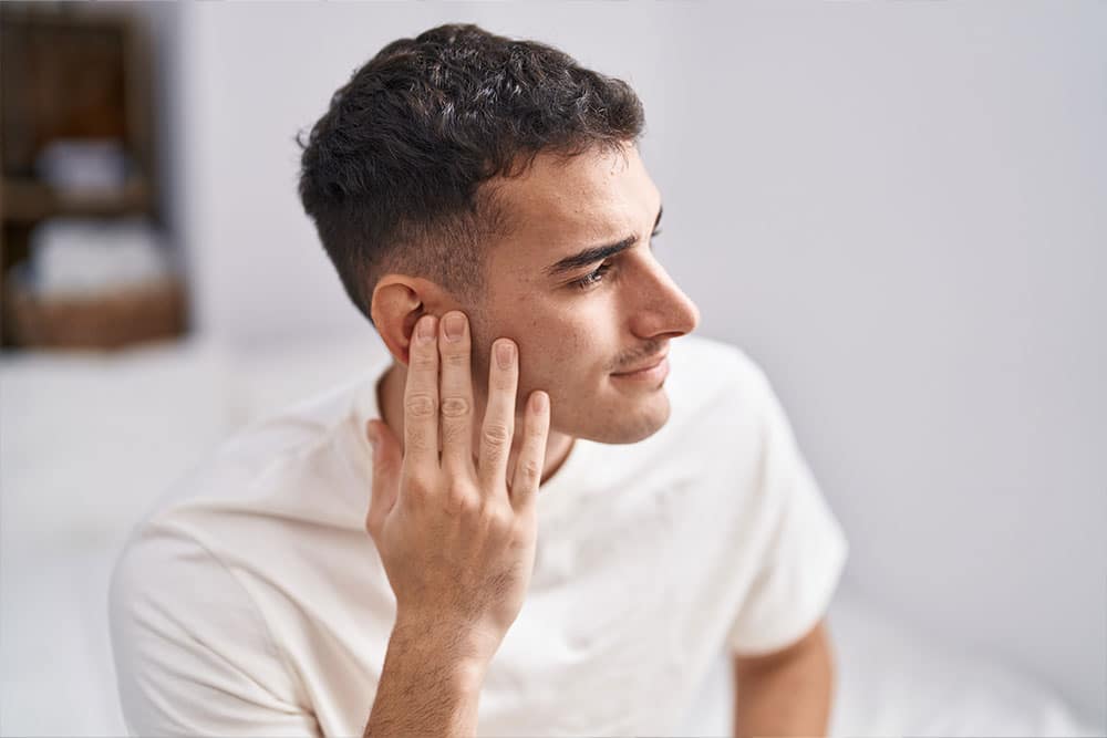 Man experiencing tinnitus